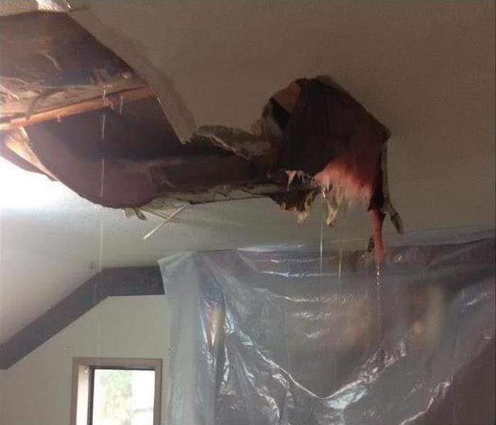 Hole on a ceiling, water leaking through ceiling