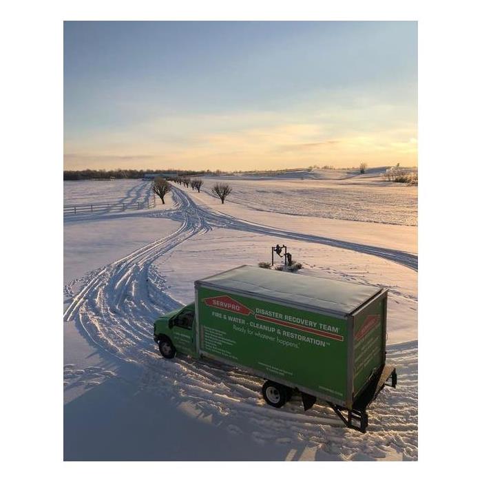 SERVPRO box truck driving across a snow covered road in Texas